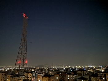 Low angle view of illuminated buildings against sky at night