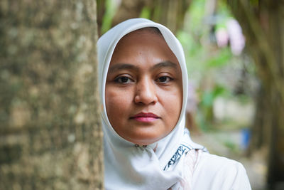 Close-up portrait of young woman standing outdoors