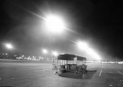 Illuminated street light against sky at night