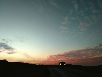 Scenic view of silhouette land against sky at sunset