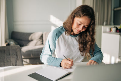 Young woman using laptop at home