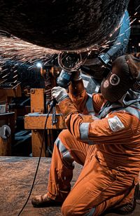 Rear view of man working at construction site