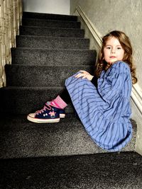 Portrait of a teenage girl sitting on staircase