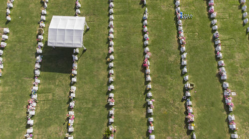 Aerial view of tombstone on field during sunny day