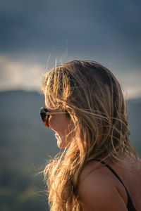 Portrait of woman with sunglasses against sky