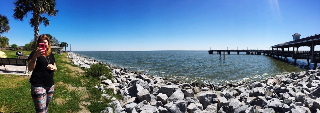 sea, horizon over water, beach, sky, water, clear sky, blue, sunlight, nature, large group of people, scenics, outdoors, beauty in nature, tranquility, women, tree, real people, day, people, adult, adults only