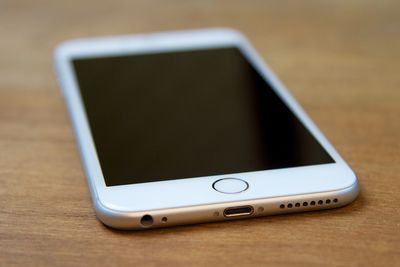 Close-up of smart phone on wooden table