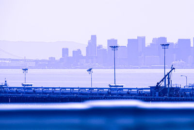 Bridge over river against city