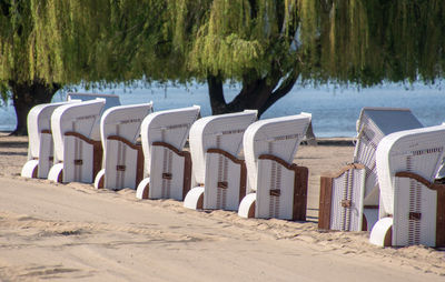 View of beach chairs in a row on beach