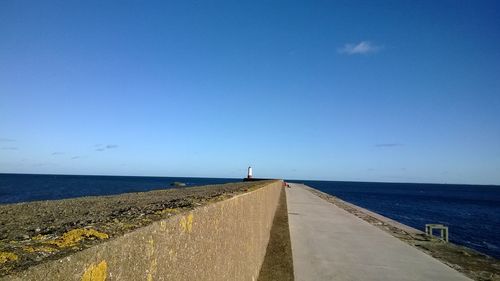 Scenic view of sea against blue sky