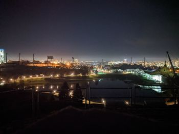 High angle view of city lit up at night