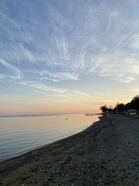 Scenic view of beach against sky during sunset