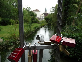 Close-up of padlocks hanging on metal by river