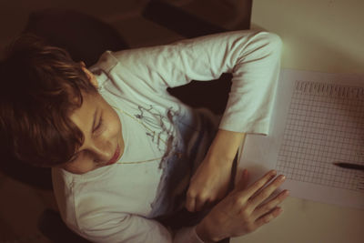 High angle view of boy sitting at home