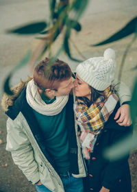 Couple embracing while wearing warm clothing in city