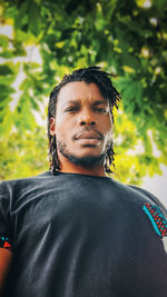 Portrait of man standing against plants