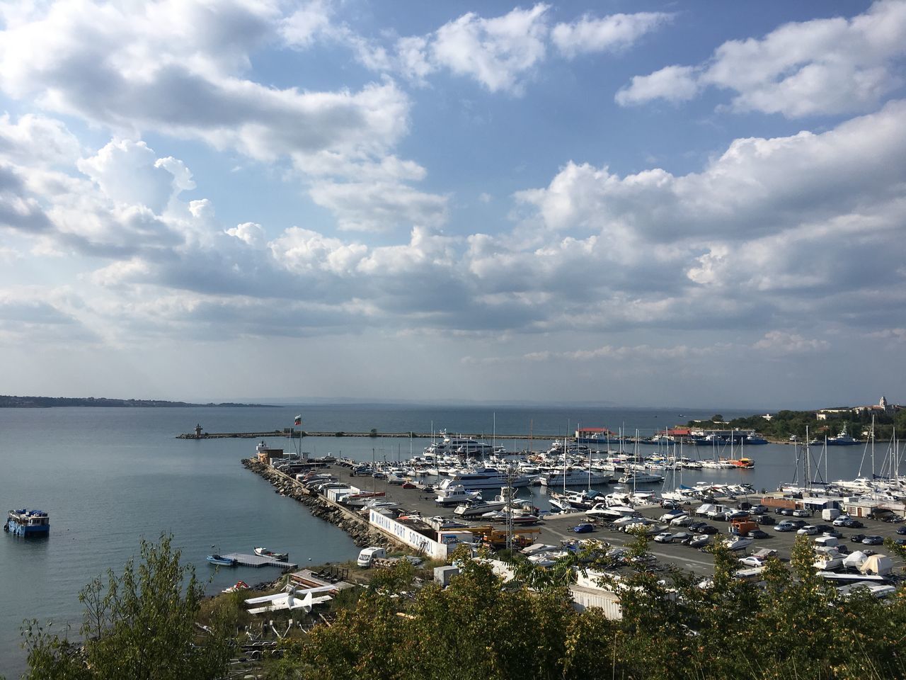 cloud - sky, sky, water, sea, architecture, transportation, built structure, high angle view, building exterior, city, nature, mode of transportation, no people, day, nautical vessel, outdoors, scenics - nature, horizon, beauty in nature, horizon over water, cityscape, sailboat, marina, yacht