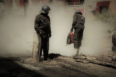 Rear view of people walking in city
