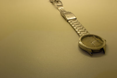 High angle view of clock on table against wall