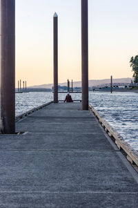 Pier over sea against clear sky