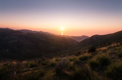 Scenic view of mountains against sky during sunset