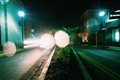 Illuminated city street at night
