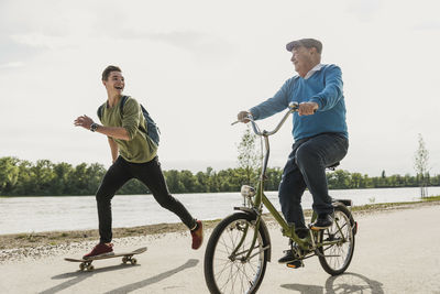 Grandfather and grandson having fun together at riverside