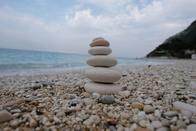 Stones on beach against sky