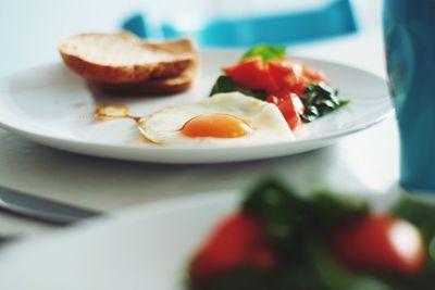 Close-up of fresh breakfast served in plates on table