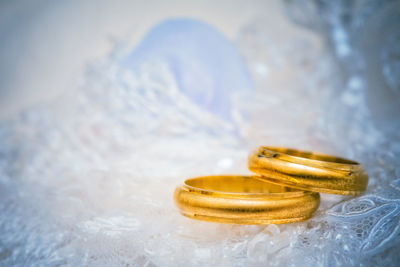 Close-up of wedding rings on table