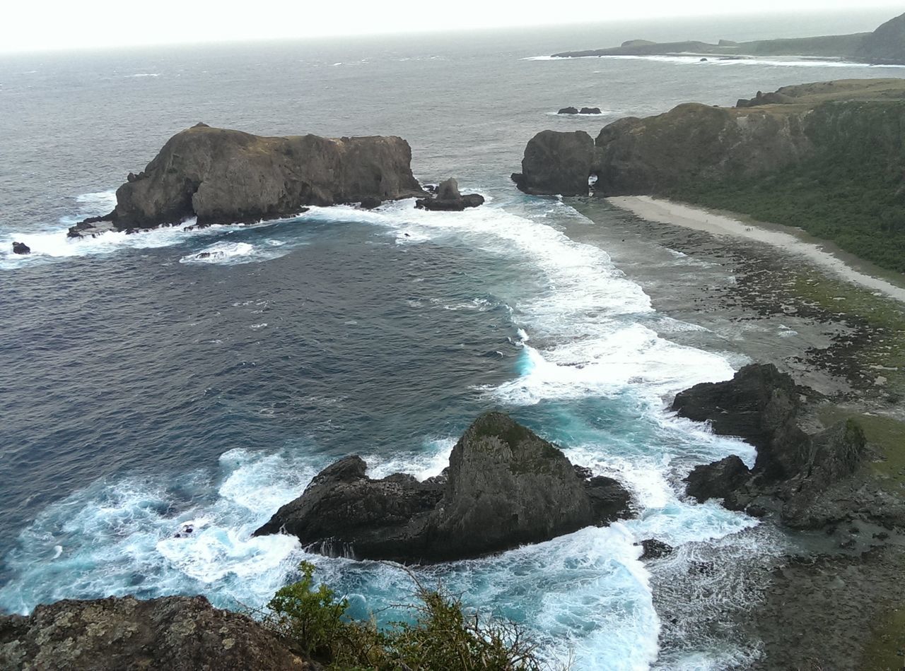 sea, water, horizon over water, scenics, beauty in nature, rock - object, wave, surf, rock formation, tranquil scene, nature, tranquility, rock, coastline, shore, beach, idyllic, high angle view, cliff, seascape