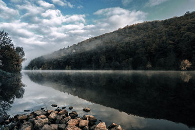 Scenic view of lake and mountains against sky