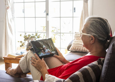 Senior woman digital table while sitting at home