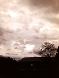 Low angle view of buildings against cloudy sky