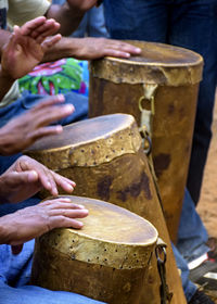 Percussionists group playing a rudimentary atabaque made with leather and wood