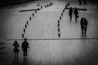 High angle view of silhouette people walking on road