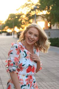 Portrait of smiling young woman standing outdoors