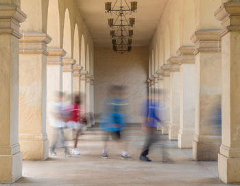 Blur image of people walking in corridor