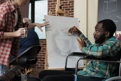 Side view of business colleagues working in office