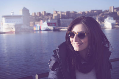 Portrait of smiling young woman in city