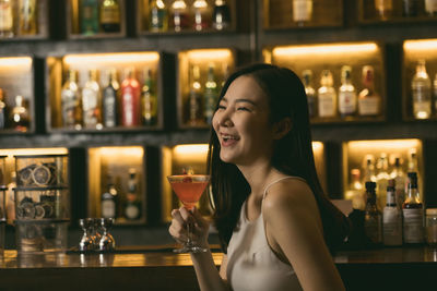 Full length of a woman drinking glass