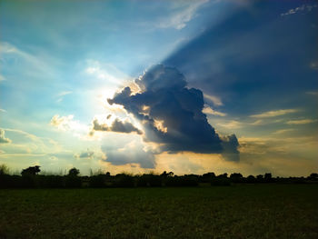 Scenic view of field against sky during sunset