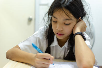 School girl studying at table