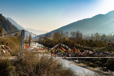 Suspension bridge at sunrise with mountain background