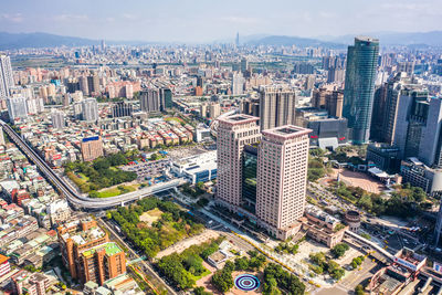 High angle view of modern buildings in city against sky