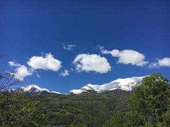 Scenic view of mountains against blue sky