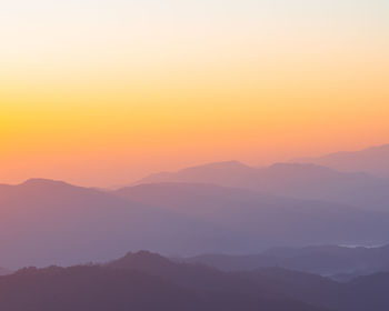 Scenic view of silhouette mountains against sky during sunset