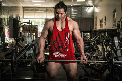 Portrait of young man standing in gym