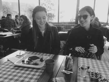 Portrait of young woman sitting at restaurant