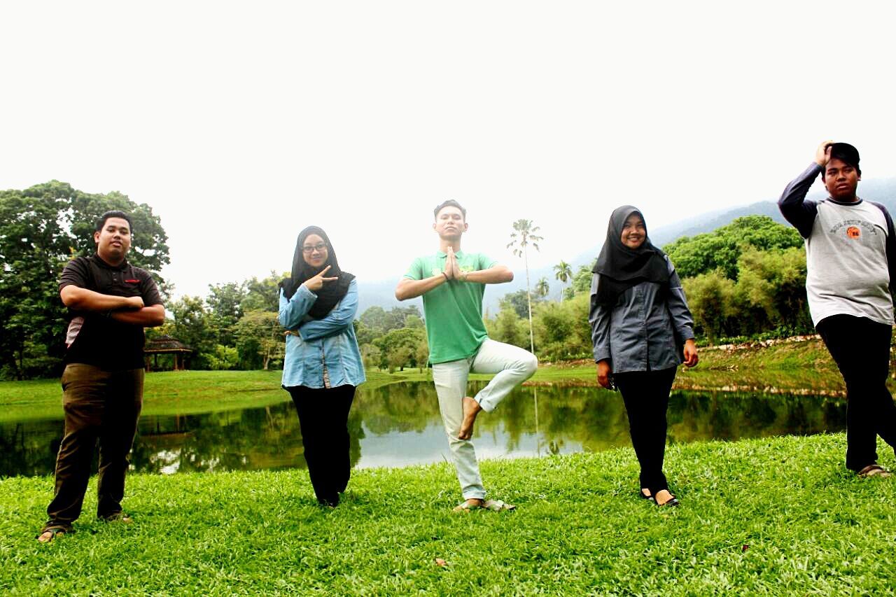 togetherness, lifestyles, leisure activity, casual clothing, grass, bonding, friendship, young men, love, smiling, person, standing, happiness, clear sky, sibling, boys, men, front view